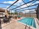 Screened-in pool with multiple lounge chairs and an outdoor dining area, perfect for outdoor relaxation and entertainment at 3505 Rhapsody St, St Cloud, FL 34772