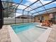 Relaxing screened pool with lounge chairs and tile border is perfect for the summer heat at 3505 Rhapsody St, St Cloud, FL 34772