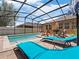 Inviting screened-in pool area with lounge seating and views of the landscaped backyard, perfect for relaxation at 3505 Rhapsody St, St Cloud, FL 34772