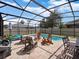 Private screened-in pool area with a pool, lounge chairs, and outdoor dining set for relaxation and entertainment at 3505 Rhapsody St, St Cloud, FL 34772