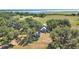 Aerial view of the home on expansive lot with mature trees and water in the distance at 3650 Lake Tohopekaliga Rd, St Cloud, FL 34772