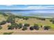 Picturesque aerial view of property with lake frontage and mature trees, a serene landscape at 3650 Lake Tohopekaliga Rd, St Cloud, FL 34772