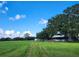 Large green pasture with a home, offering ample space and a serene country setting at 3650 Lake Tohopekaliga Rd, St Cloud, FL 34772