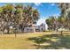 Charming home surrounded by grand oak trees and lush greenery, offering a serene, country atmosphere at 3650 Lake Tohopekaliga Rd, St Cloud, FL 34772