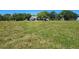Picturesque front yard featuring a well-maintained lawn and charming home surrounded by mature trees at 3650 Lake Tohopekaliga Rd, St Cloud, FL 34772