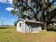 Outbuilding on a grassy lot under shade trees at 3650 Lake Tohopekaliga Rd, St Cloud, FL 34772