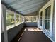 Screened-in porch with views of mature trees, wood floors and windows at 3650 Lake Tohopekaliga Rd, St Cloud, FL 34772