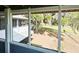 View from the screened-in porch shows the peaceful yard and mature trees beyond at 3650 Lake Tohopekaliga Rd, St Cloud, FL 34772