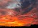 Dramatic sunset sky with vibrant orange and purple hues over the horizon at 3650 Lake Tohopekaliga Rd, St Cloud, FL 34772
