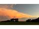 Scenic sunset view with vibrant orange and pink clouds over the landscape at 3650 Lake Tohopekaliga Rd, St Cloud, FL 34772