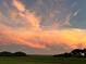Scenic sunset view with vibrant orange and pink clouds over the landscape at 3650 Lake Tohopekaliga Rd, St Cloud, FL 34772