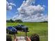 Expansive green lawn with a picturesque view, complemented by mature trees and vehicles parked nearby at 3650 Lake Tohopekaliga Rd, St Cloud, FL 34772