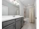 Bathroom with gray vanity and a shower-tub combo with a decorative shower curtain at 4233 Mistwood St, Winter Garden, FL 34787