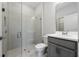 Modern bathroom featuring a glass-enclosed shower, gray vanity, and stylish tile flooring, offering a sleek design at 4233 Mistwood St, Winter Garden, FL 34787