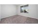 Cozy bedroom with neutral carpet and a large window providing natural light, creating a serene atmosphere at 4233 Mistwood St, Winter Garden, FL 34787