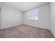 Bedroom featuring plush carpet and a bright window overlooking the front yard at 4233 Mistwood St, Winter Garden, FL 34787