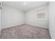Bright bedroom with plush carpet and a window overlooking the backyard at 4233 Mistwood St, Winter Garden, FL 34787
