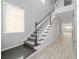 Bright foyer features a carpeted staircase, light-colored flooring, and natural light streaming in from a nearby window at 4233 Mistwood St, Winter Garden, FL 34787