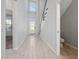 Inviting foyer featuring tile flooring, high ceilings, and a staircase, complemented by a half-bath and a view into another room at 4233 Mistwood St, Winter Garden, FL 34787