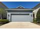 Charming home exterior with a two-car garage, well-maintained landscaping, and a concrete driveway at 4233 Mistwood St, Winter Garden, FL 34787