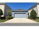 Charming home exterior with a two-car garage, well-maintained landscaping, and a concrete driveway at 4233 Mistwood St, Winter Garden, FL 34787