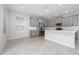 Spacious kitchen with modern appliances, gray cabinets, and a large island, perfect for cooking and entertaining at 4233 Mistwood St, Winter Garden, FL 34787
