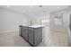 Modern kitchen featuring a center island with stainless steel dishwasher and light grey cabinetry at 4233 Mistwood St, Winter Garden, FL 34787