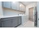 Well-equipped laundry room with washer, dryer, cabinets and counter space at 4233 Mistwood St, Winter Garden, FL 34787