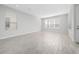 Spacious living room with light grey wood-look flooring and bright natural light from several windows at 4233 Mistwood St, Winter Garden, FL 34787