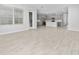 Open-concept floorplan with light grey wood-look flooring that connects to the kitchen at 4233 Mistwood St, Winter Garden, FL 34787