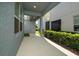 Covered patio area with neat shrubbery and easy access to the side yard at 4233 Mistwood St, Winter Garden, FL 34787