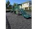 Community playground with a green playset featuring multiple slides and climbing structures for children at 4233 Mistwood St, Winter Garden, FL 34787