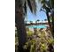 Scenic community pool featuring lounge chairs, lush tropical landscaping, and clear blue skies at 4233 Mistwood St, Winter Garden, FL 34787