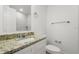 Contemporary bathroom featuring a granite vanity, white cabinets, and a tiled shower for a clean and updated look at 4510 Douglas St, Sanford, FL 32771