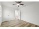 A bedroom with wood-grain flooring, two doors, and a ceiling fan at 4510 Douglas St, Sanford, FL 32771