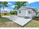 Side view of the home featuring an exterior concrete parking pad and neutral color palette at 4510 Douglas St, Sanford, FL 32771