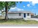 Charming single-story home with a blue front door and a well-maintained yard at 4510 Douglas St, Sanford, FL 32771