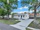 Charming single-story home with a well-maintained lawn and long driveway at 4510 Douglas St, Sanford, FL 32771