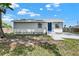 Single-story home featuring a well-manicured yard and clean gray exterior at 4510 Douglas St, Sanford, FL 32771