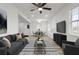 Open-concept living room and dining area with modern furnishings and wood-look floors create a welcoming and stylish space at 4510 Douglas St, Sanford, FL 32771