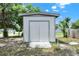 A storage shed with double doors offering convenient storage space on the property at 4510 Douglas St, Sanford, FL 32771