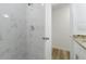 A bright shower with marble-like tile and a new showerhead at 4510 Douglas St, Sanford, FL 32771