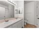 Bright bathroom features double sinks, large mirrors, and neutral tile flooring at 4897 Cypress Woods Dr # 6314, Orlando, FL 32811