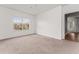 Bright, carpeted bedroom with a window and a view into another carpeted room at 4897 Cypress Woods Dr # 6314, Orlando, FL 32811