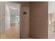 View of the entrance door, revealing a glimpse of the interior with tile flooring and neutral wall paint at 4897 Cypress Woods Dr # 6314, Orlando, FL 32811