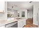 Bright kitchen showcasing granite countertops, stainless steel appliances, and views into living area at 4897 Cypress Woods Dr # 6314, Orlando, FL 32811