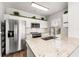 Modern kitchen featuring stainless steel appliances, granite countertops, and white cabinets with greenery on top at 4897 Cypress Woods Dr # 6314, Orlando, FL 32811