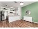 Charming kitchen area with stainless steel appliances, island counter, and a stylish green accent wall at 4897 Cypress Woods Dr # 6314, Orlando, FL 32811