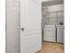 Laundry room showing a side-by-side washer and dryer with overhead storage at 4897 Cypress Woods Dr # 6314, Orlando, FL 32811