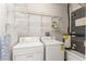 Utility closet with overhead storage, washer, dryer, water heater, and AC unit at 4897 Cypress Woods Dr # 6314, Orlando, FL 32811